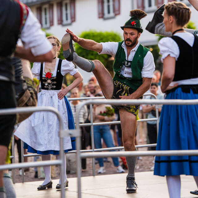Die Tänzer beim traditionellen Schuhplatteln am Kirchplatz in Oberstaufen.