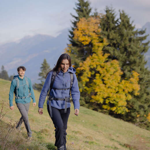 Zwei Wanderer gehen im Herbst über einen Wanderweg in Oberstaufenmit Blick auf die Nagelfluhkette.