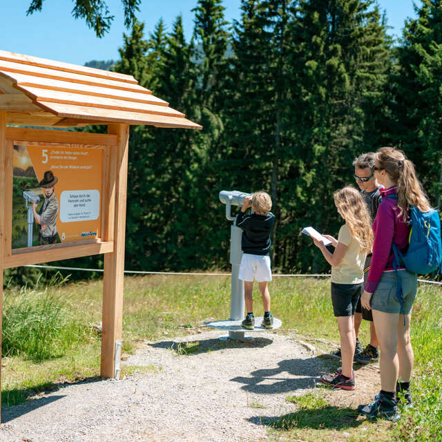 Familie an Station 5 auf dem MounTeens Detektivweg am Hündle