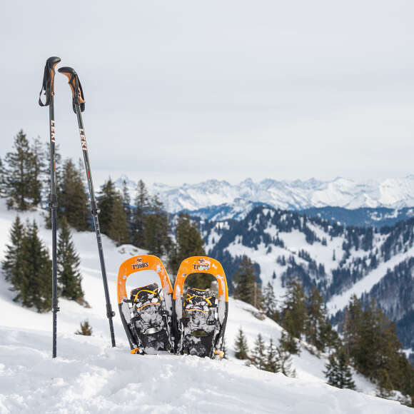 Schneeschuhe im Schnee vor dem verschneiten Panorama der Allgäuer Alpen